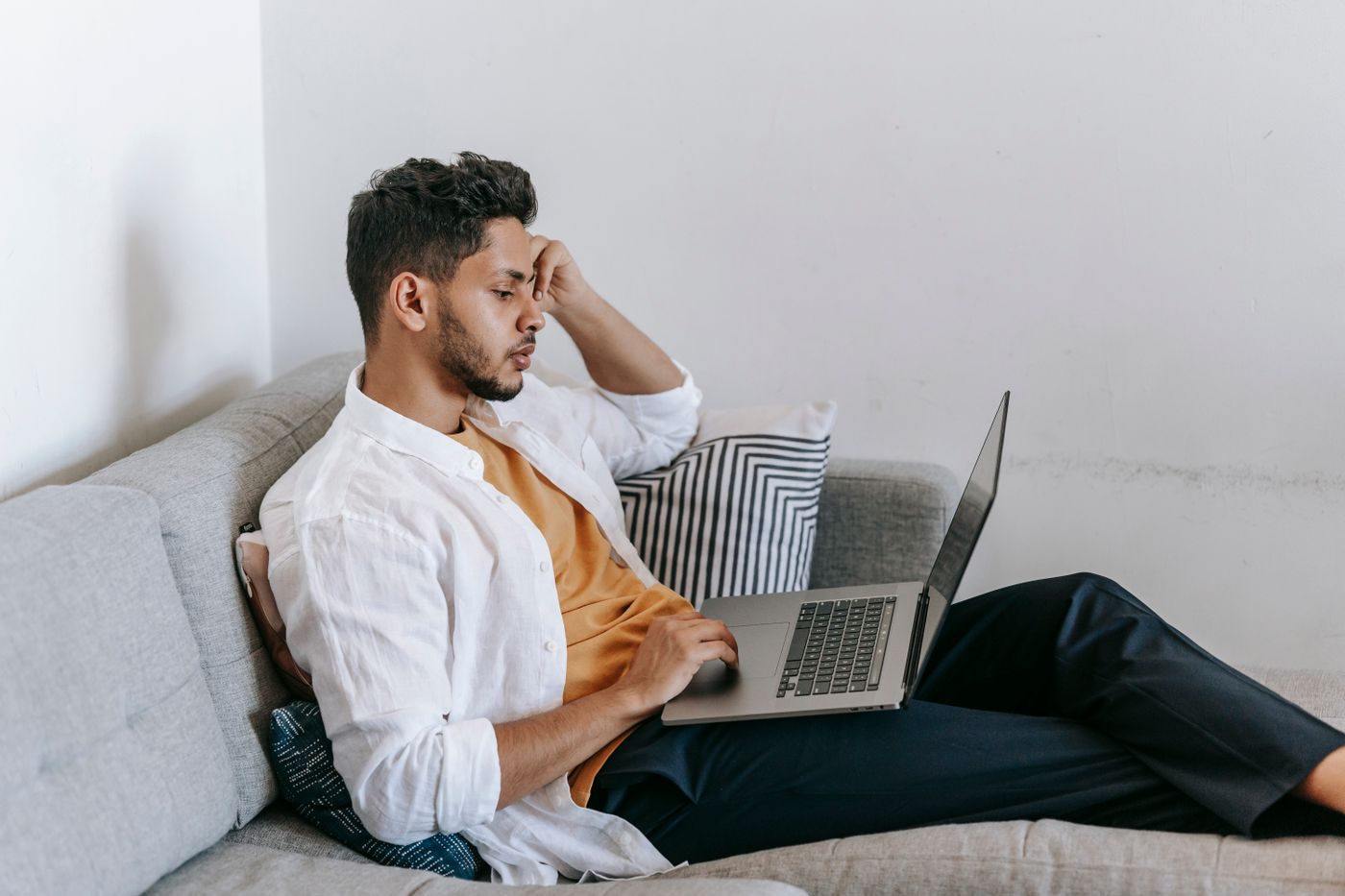 A self-employed man working on his laptop at home